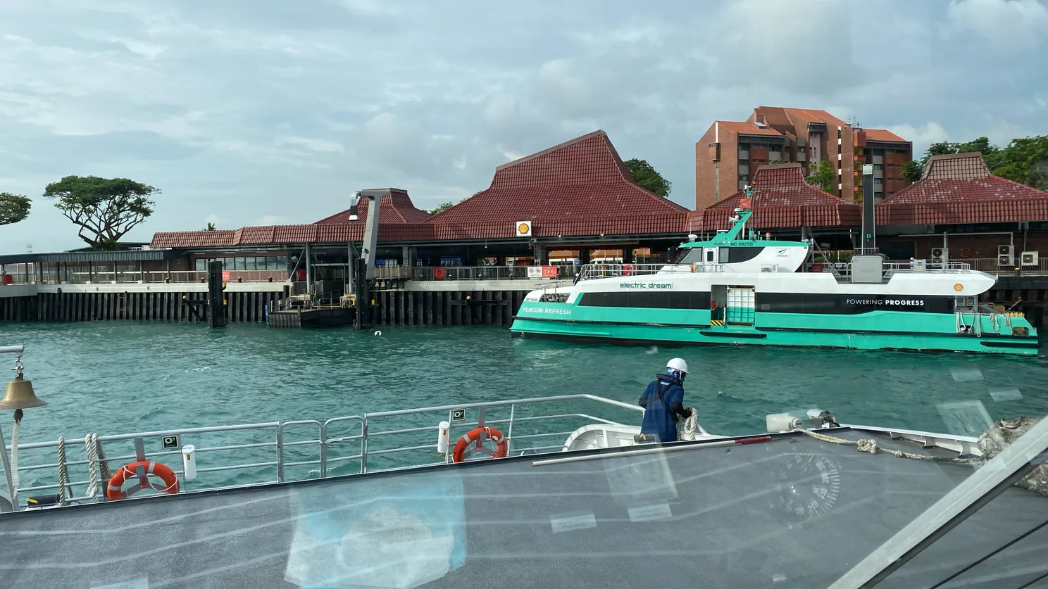 One of Shell's electric ferries arriving at Bukom Refinery Island